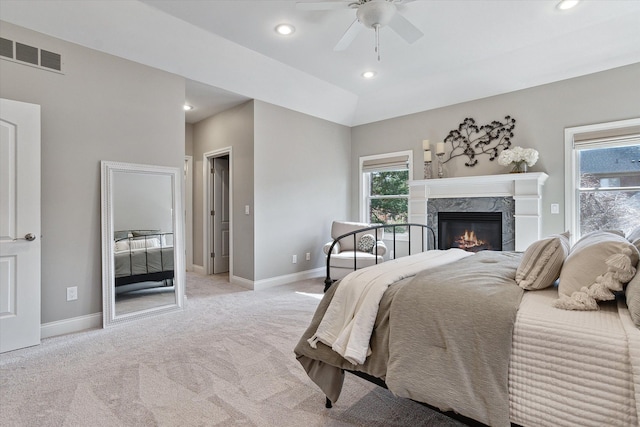 bedroom featuring light carpet, visible vents, multiple windows, and baseboards