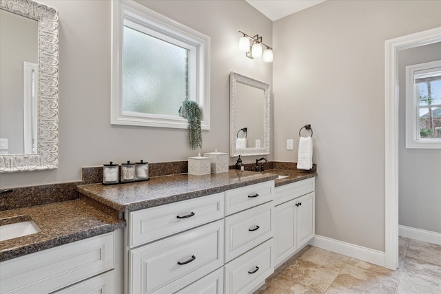 full bathroom with baseboards and vanity