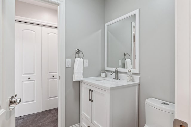 bathroom with toilet and vanity