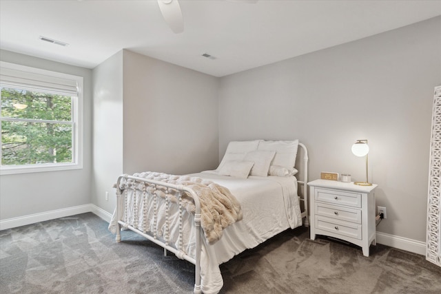 bedroom featuring visible vents, ceiling fan, baseboards, and dark colored carpet