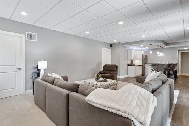 living area featuring recessed lighting, visible vents, and baseboards