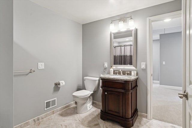 bathroom featuring visible vents, toilet, tile patterned flooring, baseboards, and vanity