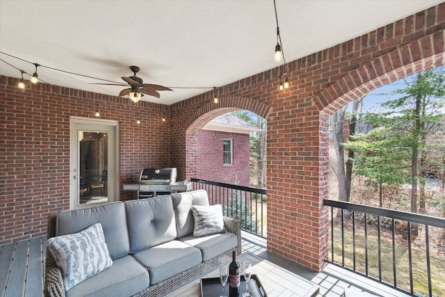 wooden deck featuring grilling area, an outdoor living space, and ceiling fan