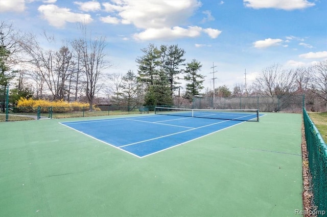 view of sport court featuring fence