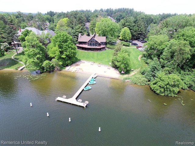 bird's eye view featuring a forest view and a water view