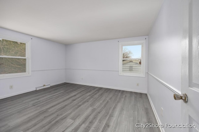 spare room with light wood-type flooring and baseboards