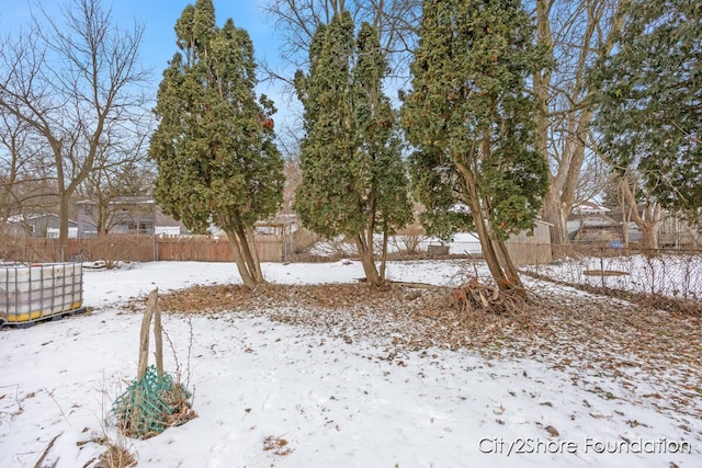 yard layered in snow with fence