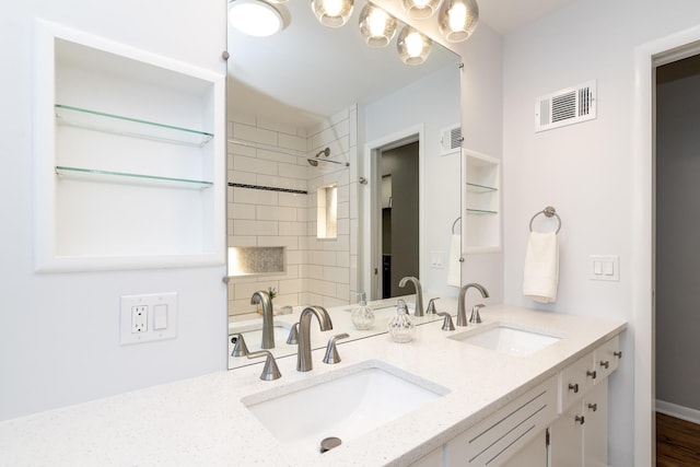 full bathroom featuring a sink, visible vents, and double vanity