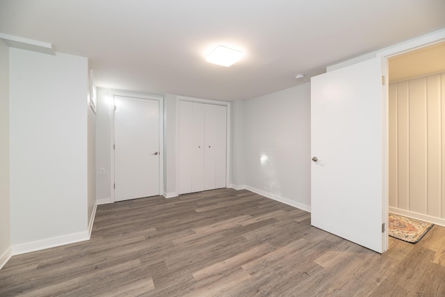 interior space with baseboards and wood finished floors