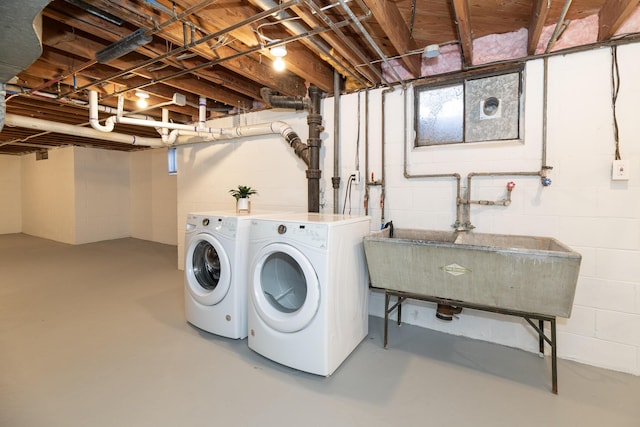 washroom featuring washing machine and clothes dryer and laundry area