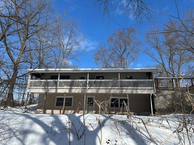 view of snow covered back of property