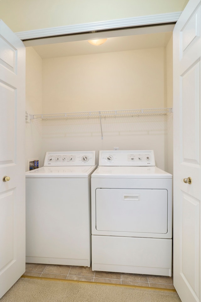 clothes washing area featuring laundry area and washing machine and clothes dryer