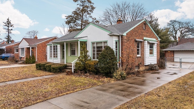 bungalow-style home with brick siding, a chimney, a gate, fence, and an outdoor structure