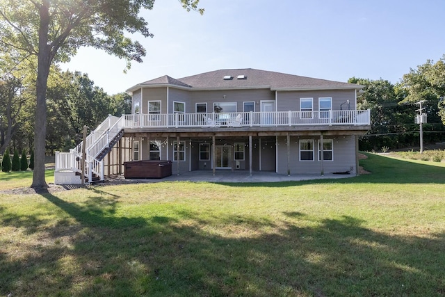 back of house with stairway, a deck, a hot tub, a lawn, and a patio