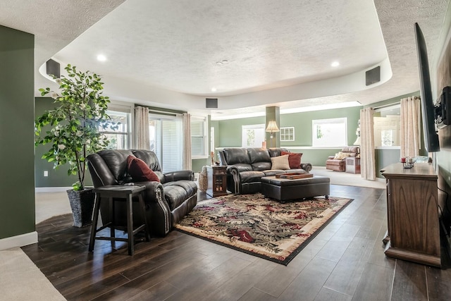 living area featuring baseboards, recessed lighting, a textured ceiling, and dark wood finished floors