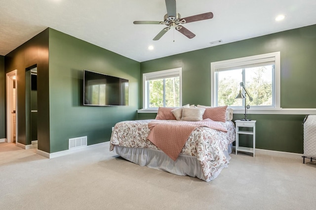 bedroom with baseboards, visible vents, light colored carpet, and recessed lighting