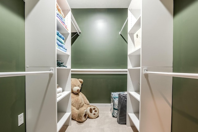 walk in closet featuring carpet floors