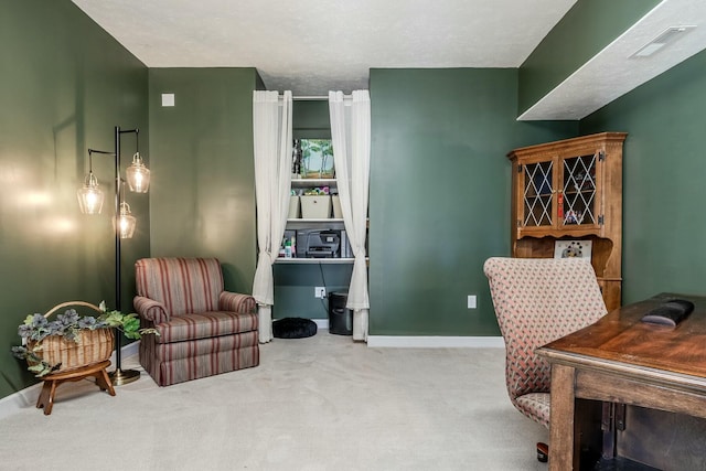 carpeted office with baseboards and visible vents