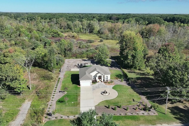 birds eye view of property featuring a view of trees