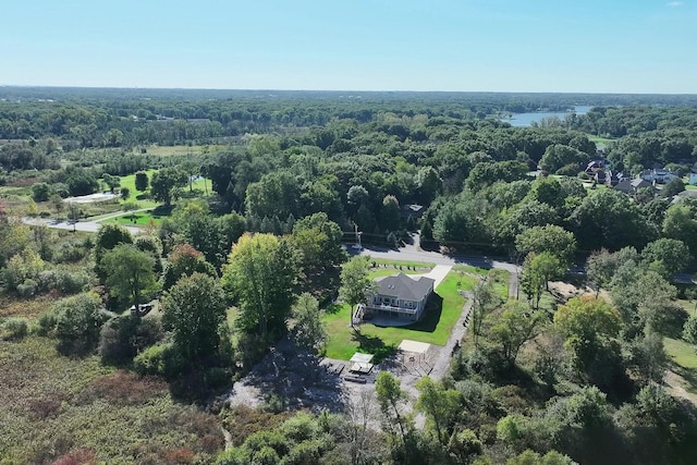 birds eye view of property with a forest view