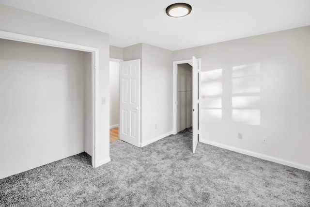 unfurnished bedroom with baseboards and carpet