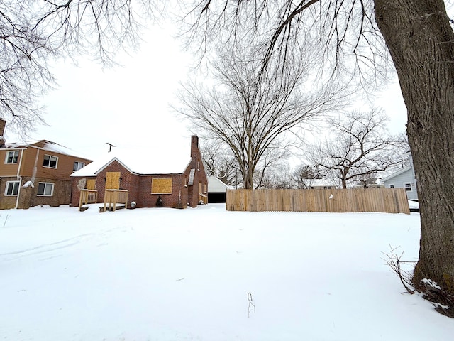 snowy yard with fence