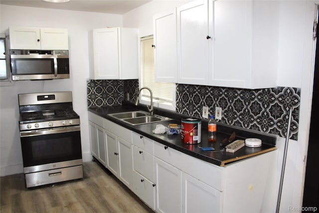 1629 Seminole St, Flint, MI 48503 - kitchen featuring appliances with stainless steel finishes, dark countertops, and white cabinets