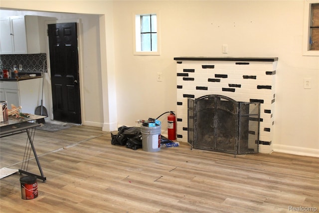 1629 Seminole St, Flint, MI 48503 - unfurnished living room with light wood-style floors and a brick fireplace