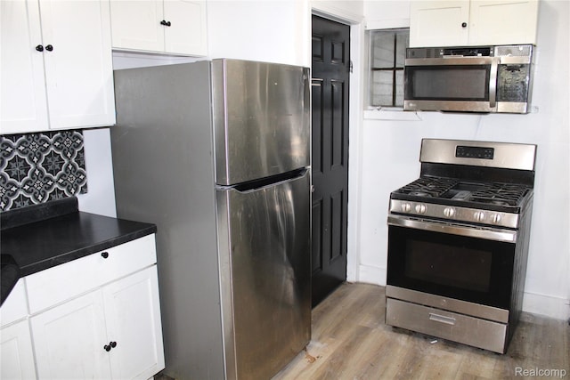 1629 Seminole St, Flint, MI 48503 - kitchen featuring stainless steel appliances, light wood-type flooring, and white cabinetry