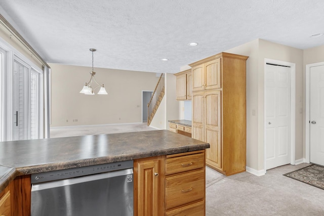 kitchen featuring hanging light fixtures, dark countertops, dishwasher, and a textured ceiling