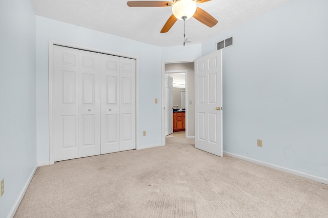 unfurnished bedroom with baseboards, visible vents, and light carpet