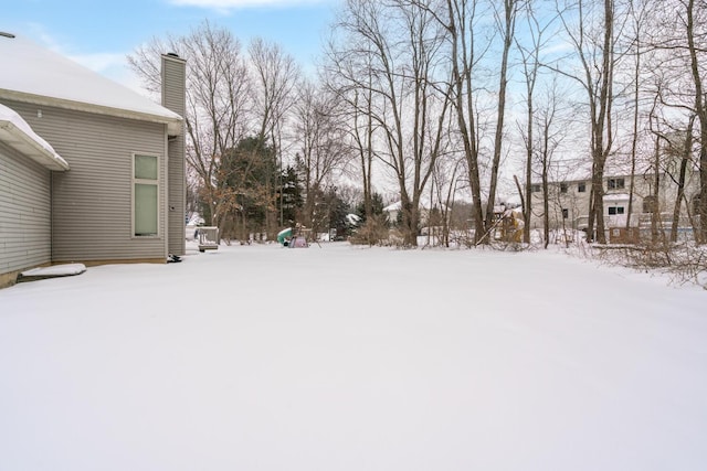 view of yard layered in snow