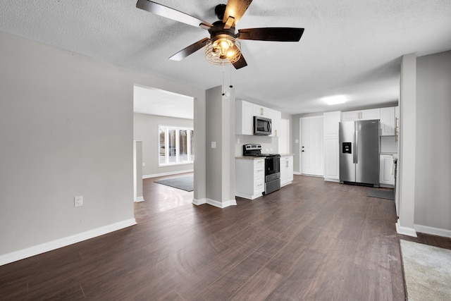 kitchen featuring light countertops, appliances with stainless steel finishes, dark wood finished floors, and white cabinetry