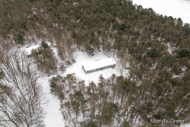 snowy aerial view featuring a forest view