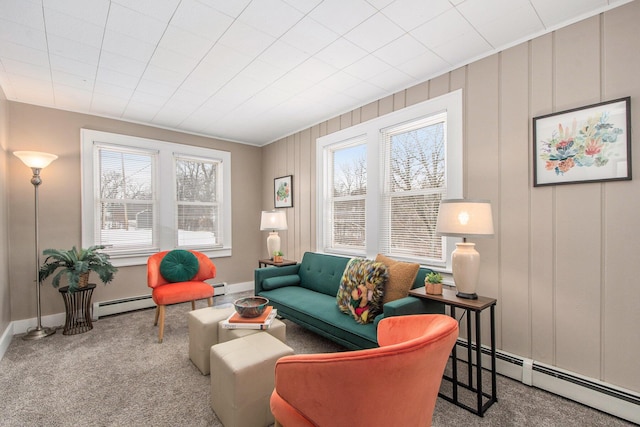 living area with baseboards, baseboard heating, and carpet