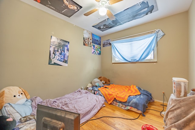 bedroom featuring ceiling fan, wood finished floors, and baseboards