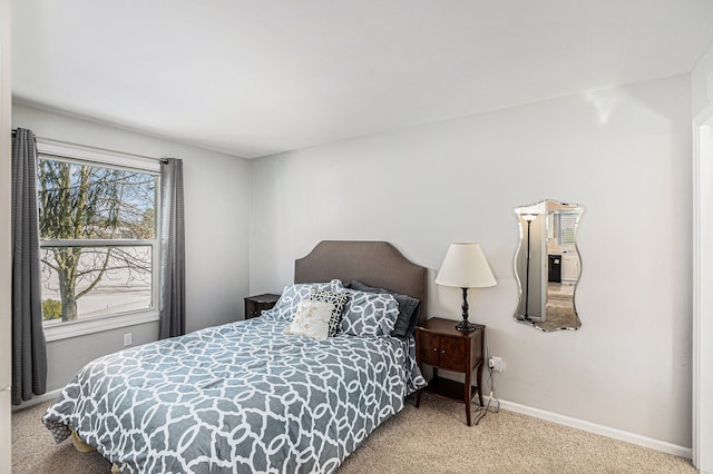 carpeted bedroom featuring baseboards