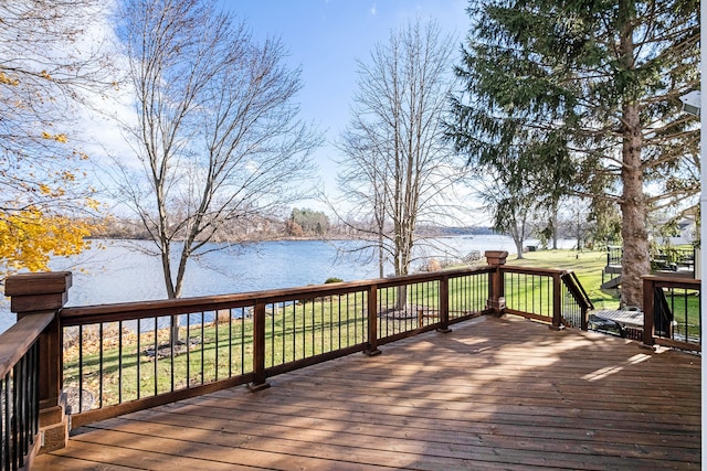 wooden deck with a yard and a water view