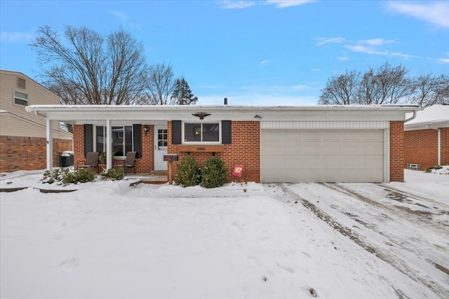 single story home featuring a garage, brick siding, a porch, and central air condition unit