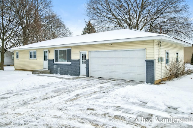 single story home with brick siding and a garage