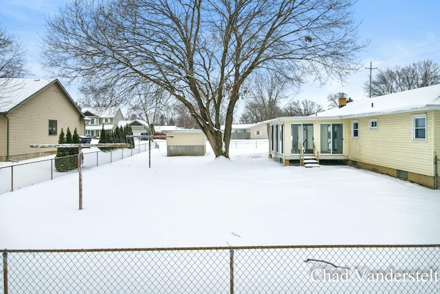 yard covered in snow featuring fence