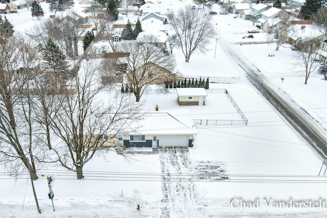 snowy aerial view featuring a residential view