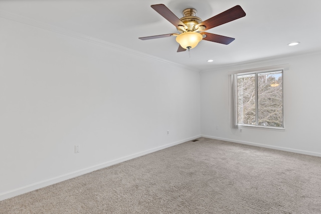 unfurnished room with recessed lighting, carpet flooring, a ceiling fan, baseboards, and crown molding