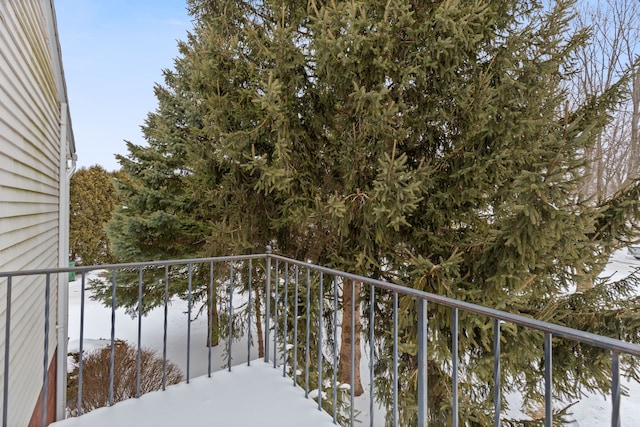 view of snow covered back of property