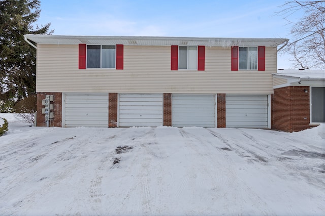 view of front of property with brick siding and an attached garage