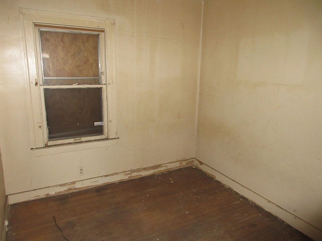 empty room with dark wood-type flooring