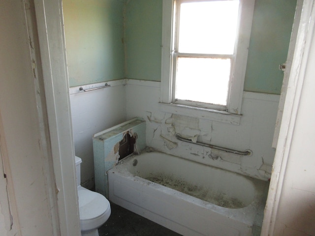 full bath featuring toilet and a bath