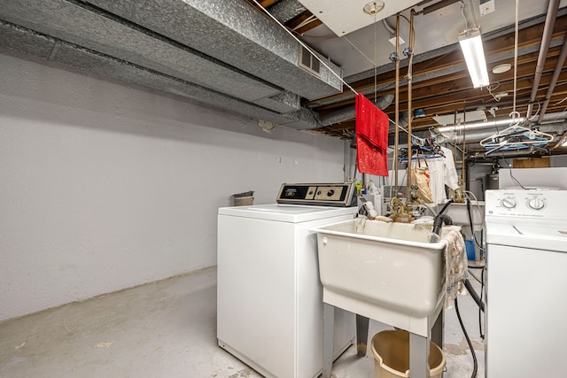 laundry area featuring laundry area, washer and clothes dryer, and a sink