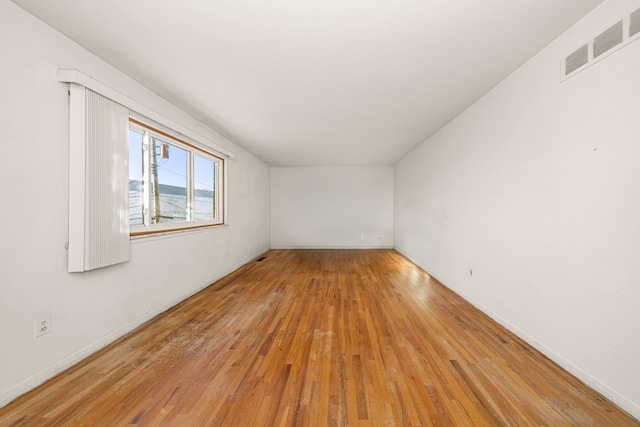 empty room featuring light wood-style flooring and visible vents