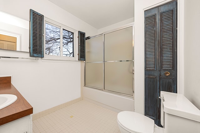 full bath with toilet, shower / bath combination with glass door, tile patterned floors, vanity, and a closet